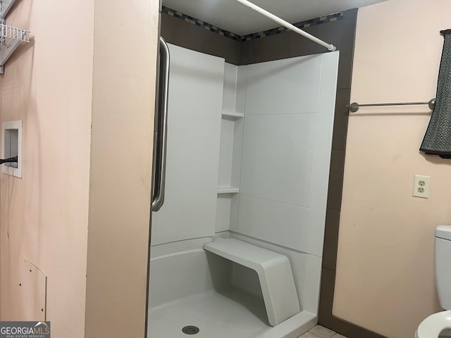 bathroom with a shower and toilet