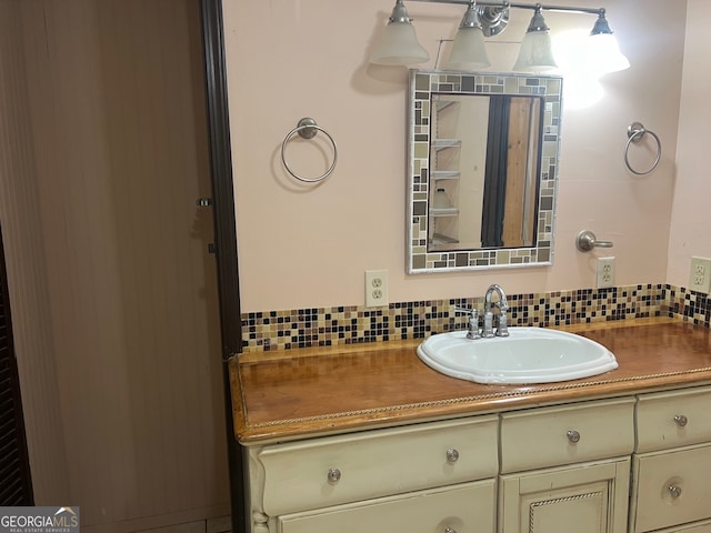 bathroom with vanity and tasteful backsplash