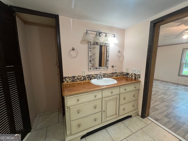 bathroom featuring backsplash, ceiling fan, hardwood / wood-style floors, and vanity