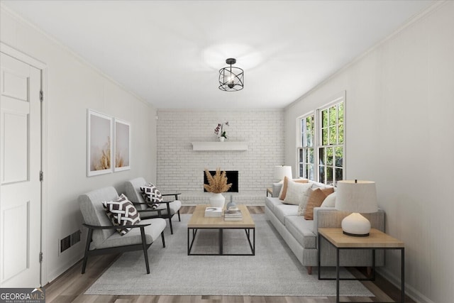 living room featuring hardwood / wood-style floors, ornamental molding, and a brick fireplace