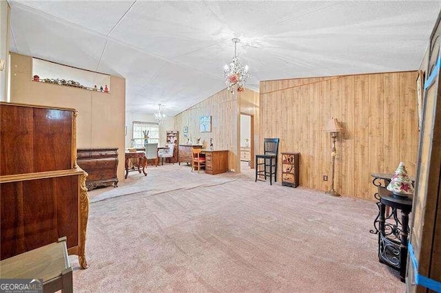 interior space featuring carpet flooring, wood walls, a chandelier, and vaulted ceiling