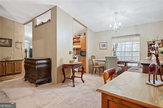 dining room featuring an inviting chandelier, light colored carpet, and vaulted ceiling