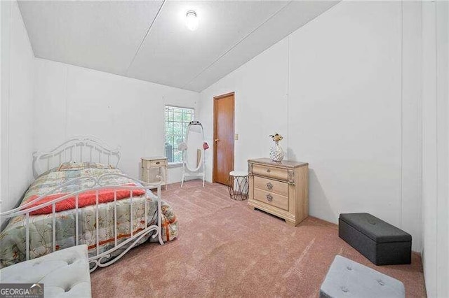 bedroom featuring lofted ceiling and carpet floors