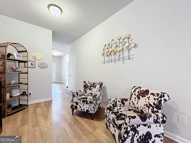 sitting room with hardwood / wood-style flooring