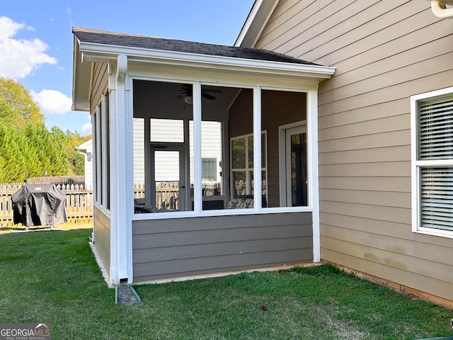 view of side of property featuring a sunroom and a lawn