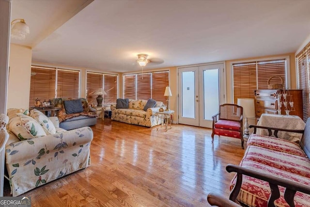 living room featuring french doors and light wood-type flooring