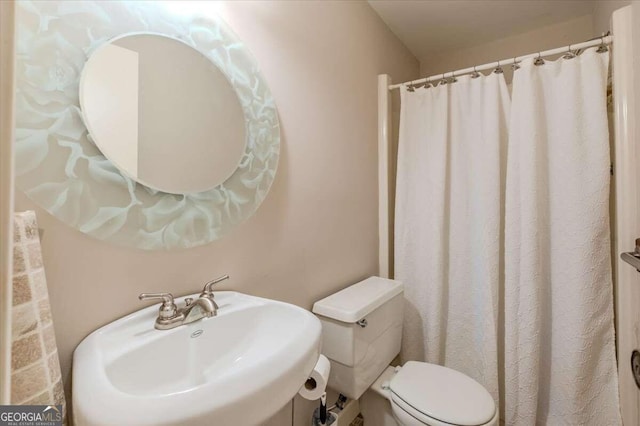 bathroom featuring sink and toilet