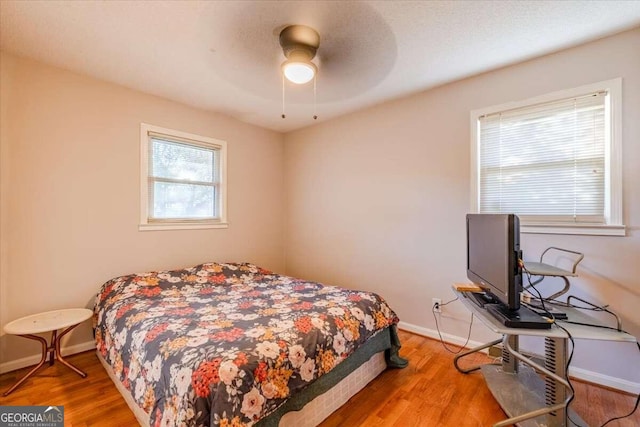 bedroom with ceiling fan and hardwood / wood-style floors