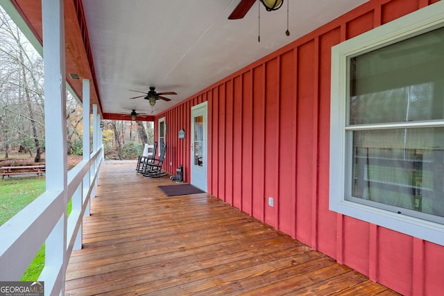 wooden terrace with covered porch and ceiling fan