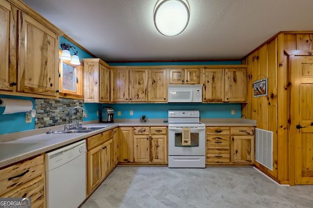 kitchen with decorative backsplash, sink, decorative light fixtures, and white appliances