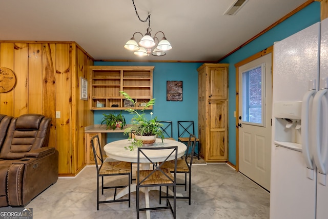 dining room with a chandelier and ornamental molding