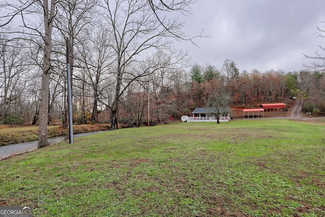 view of home's community with a yard and a wooded view