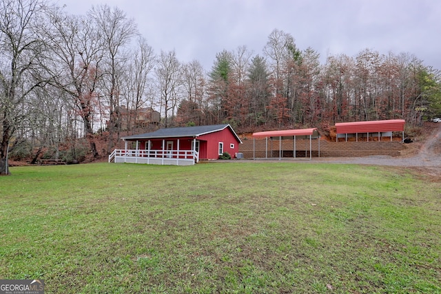 view of front facade with a view of trees and a front lawn