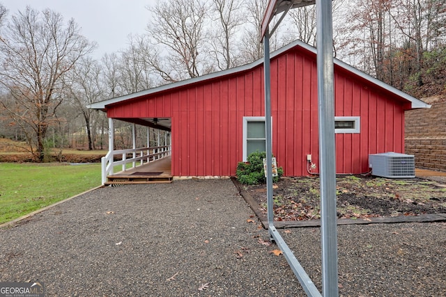 view of outdoor structure with cooling unit and a yard