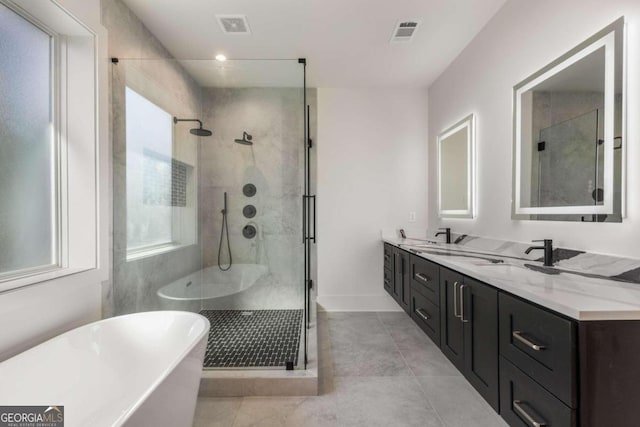 bathroom with tile patterned flooring, vanity, and plus walk in shower