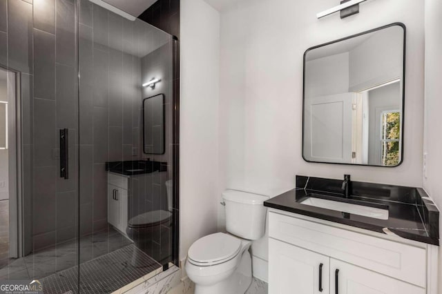 bathroom featuring vanity, toilet, and walk in shower