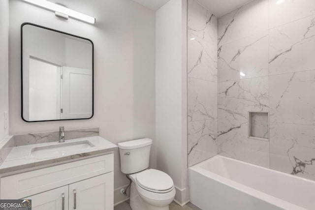 full bathroom featuring toilet, vanity, and tiled shower / bath