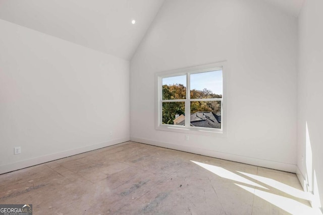 spare room featuring high vaulted ceiling