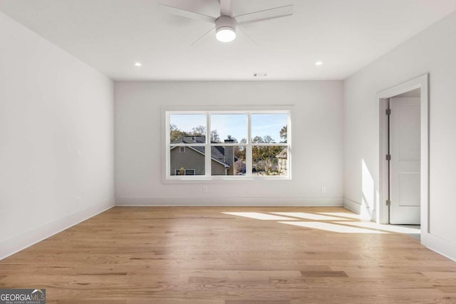 spare room featuring light hardwood / wood-style floors and ceiling fan