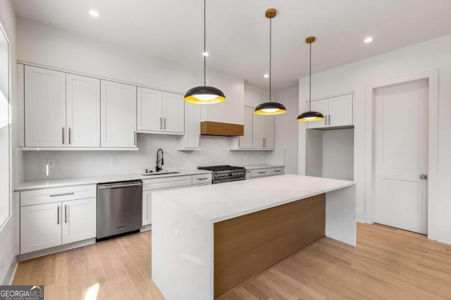 kitchen featuring appliances with stainless steel finishes, white cabinetry, and sink