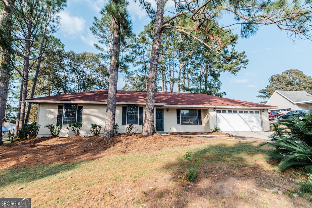 ranch-style home featuring a garage and a front yard