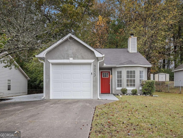 ranch-style home with a garage and a front lawn