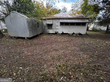 view of side of property with a storage unit