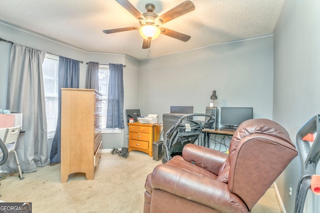 home office featuring light colored carpet, a textured ceiling, and ceiling fan