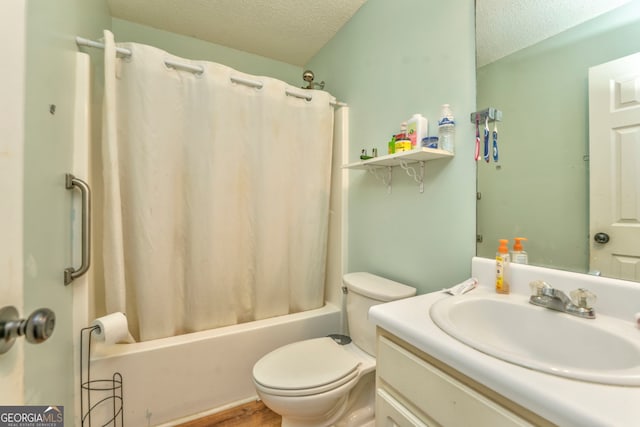 full bathroom featuring shower / tub combo with curtain, vanity, toilet, and a textured ceiling