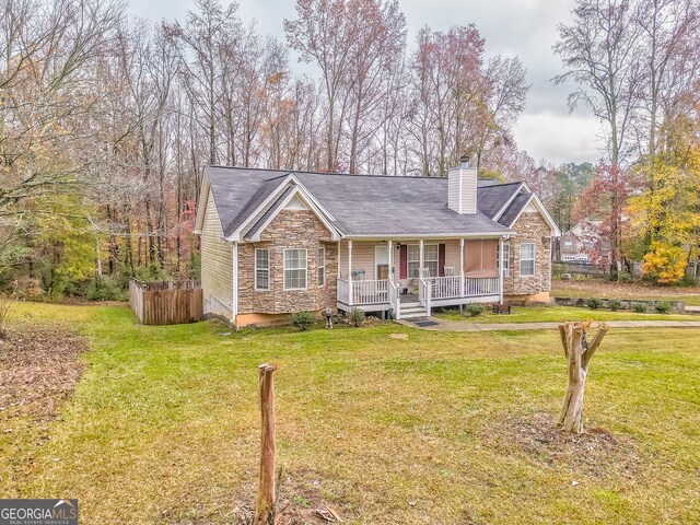 view of front of home featuring covered porch and a front yard