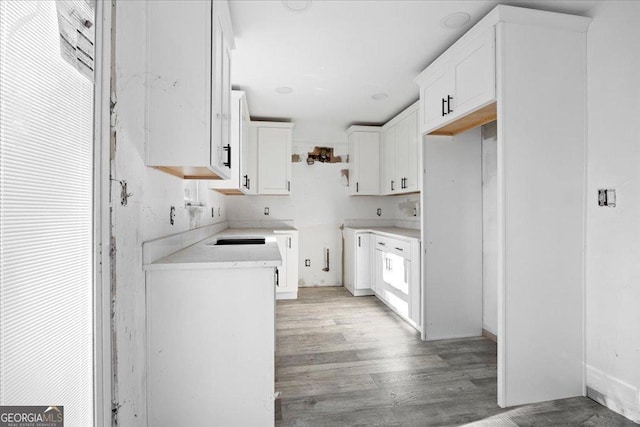 kitchen with white cabinets and light hardwood / wood-style flooring