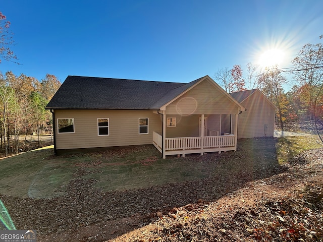 rear view of house featuring a lawn