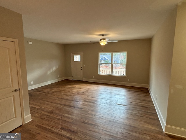 interior space with ceiling fan and dark hardwood / wood-style floors