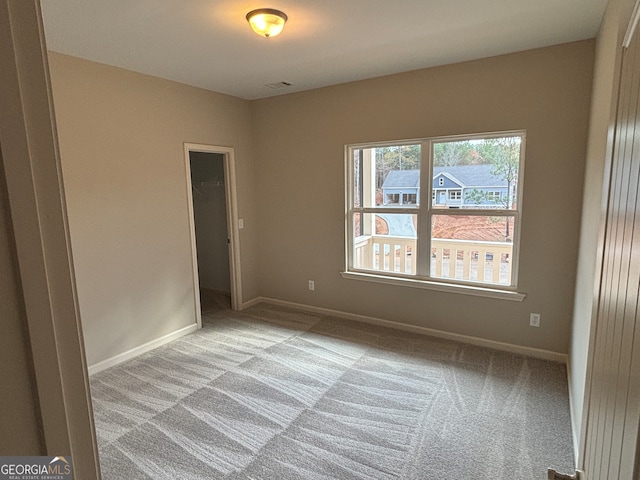 unfurnished room featuring light colored carpet