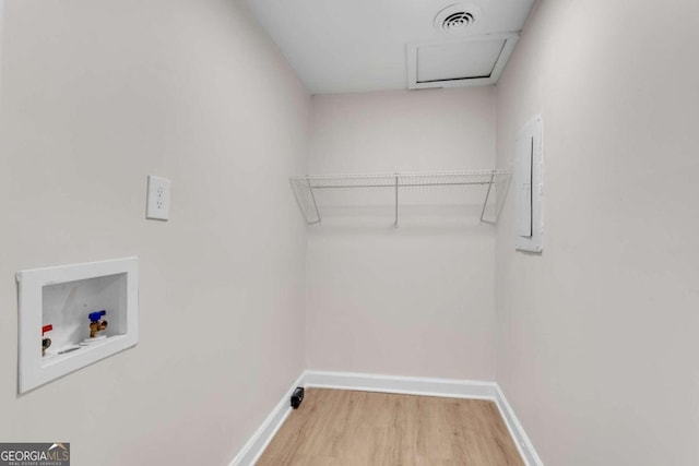 laundry area featuring washer hookup and hardwood / wood-style flooring