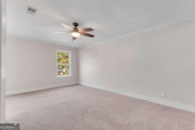 unfurnished room with light carpet, ceiling fan, and crown molding