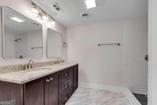 bathroom featuring vanity and tiled shower