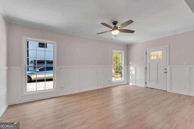 interior space featuring light hardwood / wood-style flooring, ceiling fan, and crown molding