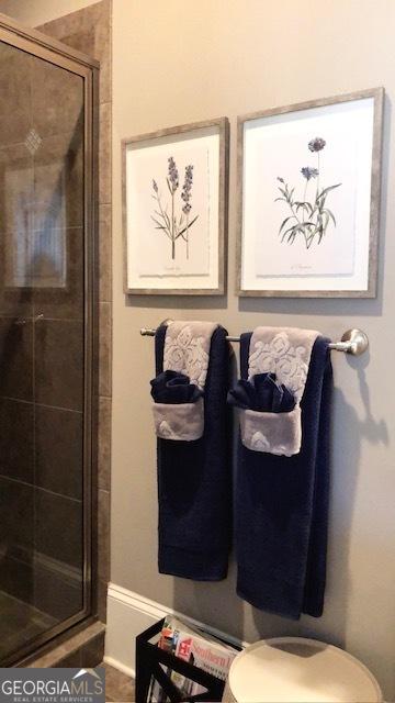 interior space featuring toilet and a shower with shower door