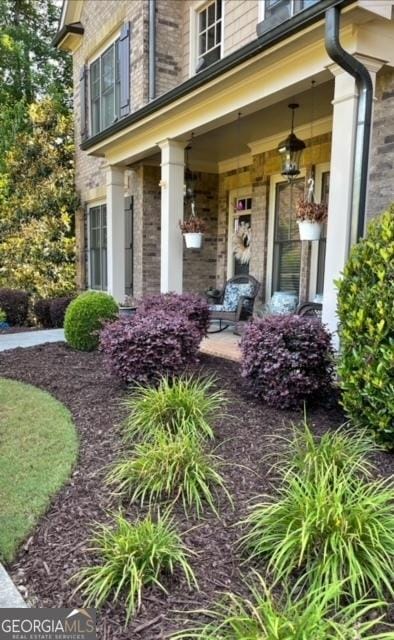 view of exterior entry featuring a porch