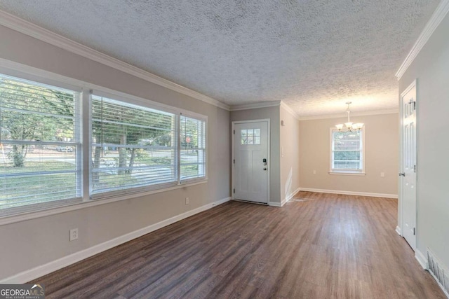 foyer featuring ornamental molding, wood-type flooring, a textured ceiling, and an inviting chandelier