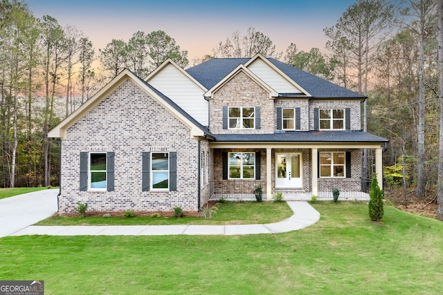 craftsman inspired home with a lawn and covered porch