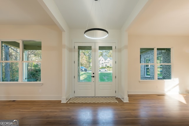 entryway with dark wood-type flooring and french doors