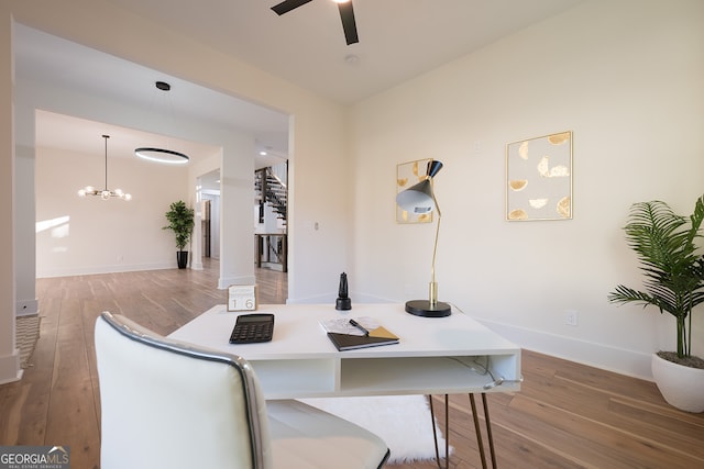 dining area featuring ceiling fan with notable chandelier and light wood-type flooring