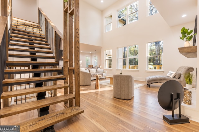 interior space with a towering ceiling and light wood-type flooring