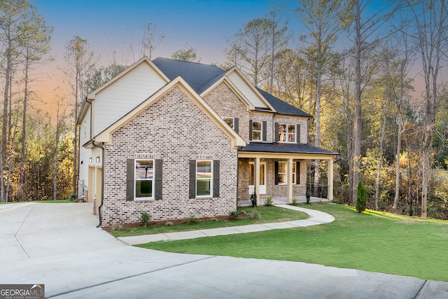 craftsman house with covered porch, a yard, and a garage