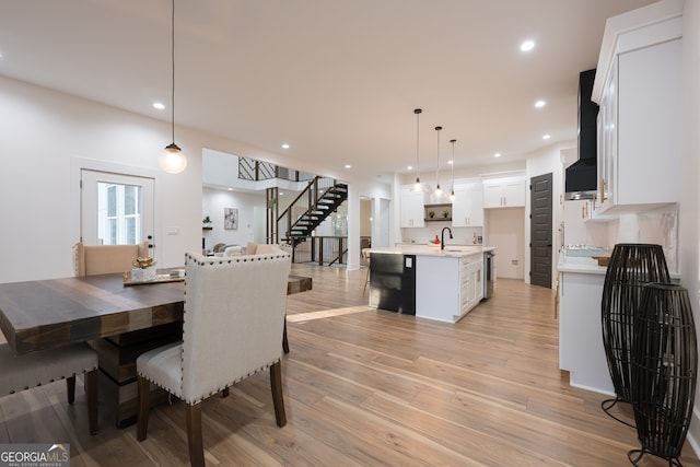 dining room with light wood-type flooring and sink