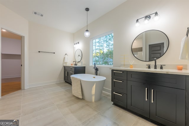 bathroom with a washtub and vanity