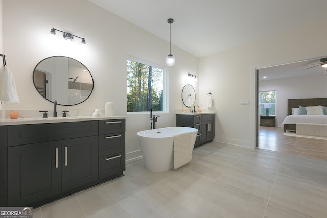 bathroom with vanity, ceiling fan, and a tub