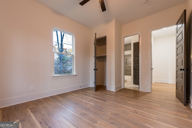 unfurnished bedroom with ceiling fan and light hardwood / wood-style floors